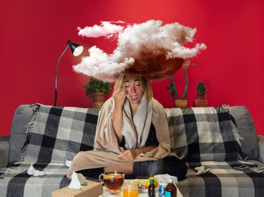 ill-young-girl-with-fever-cold-looks-suffering-feeling-sick-blue-snuffling-big-cloud-head-like-weight-feeling-ill-cold-virus-seasonal-grippe-woman-sitting-sofa-home_489646-5130.jpg