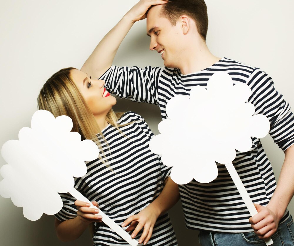 amorous-couple-holding-blank-paper-stick_118342-63512.jpg