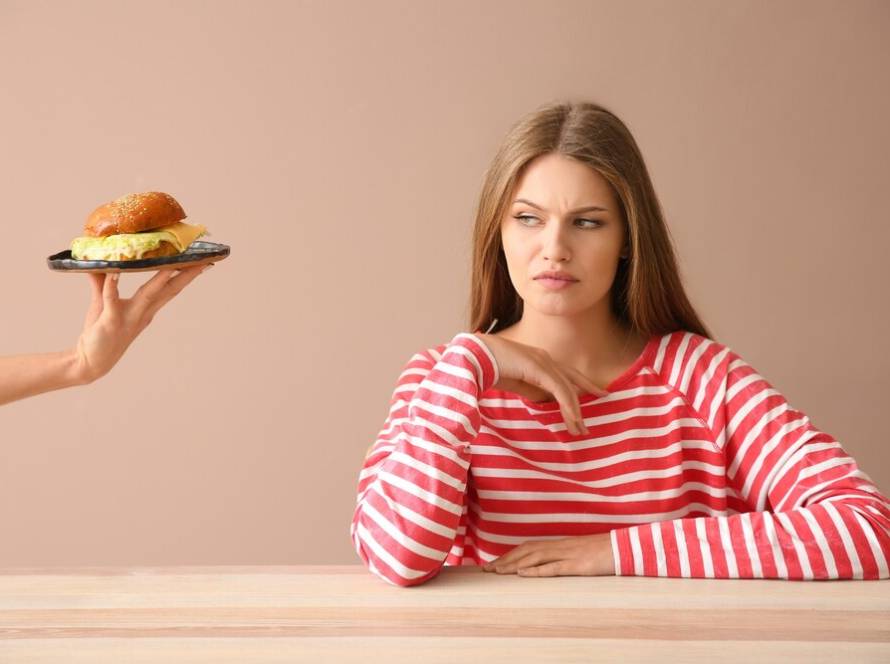 hand-suggesting-burger-displeased-young-woman-table_392895-19580.jpg