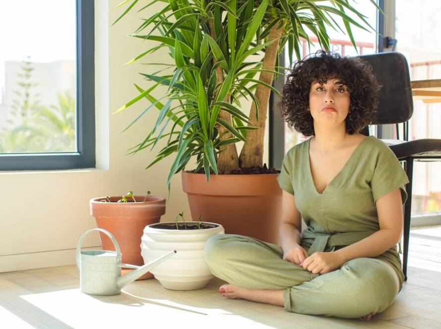 young-pretty-woman-with-watering-can-plants_1194-115696.jpg