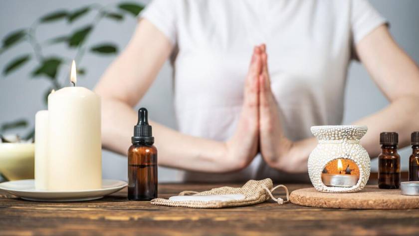 aroma-lamp-with-essential-oils-burning-candles-woman-with-her-hands-folded-namaste-pose-concept-evening-morning-rituals-meditation-harmony-balance_243391-839.jpg