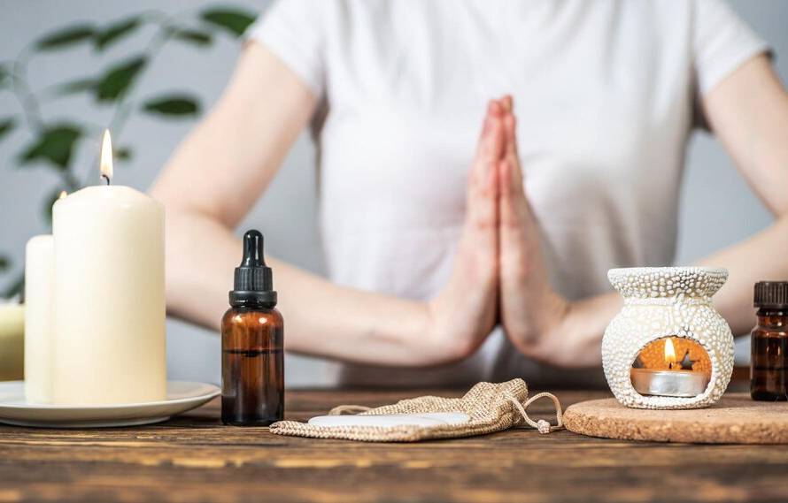 aroma-lamp-with-essential-oils-burning-candles-woman-with-her-hands-folded-namaste-pose-concept-evening-morning-rituals-meditation-harmony-balance_243391-839.jpg