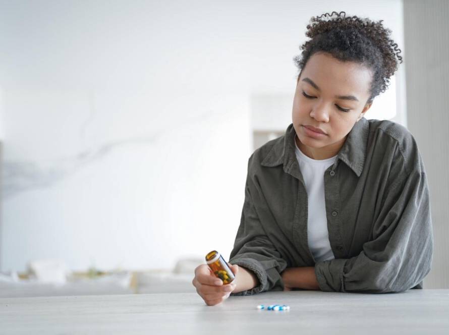 pensive-young-woman-holds-bottle-with-medicines-doubt-whether-take-pills-healthcare-copy-space_95891-8215.jpg