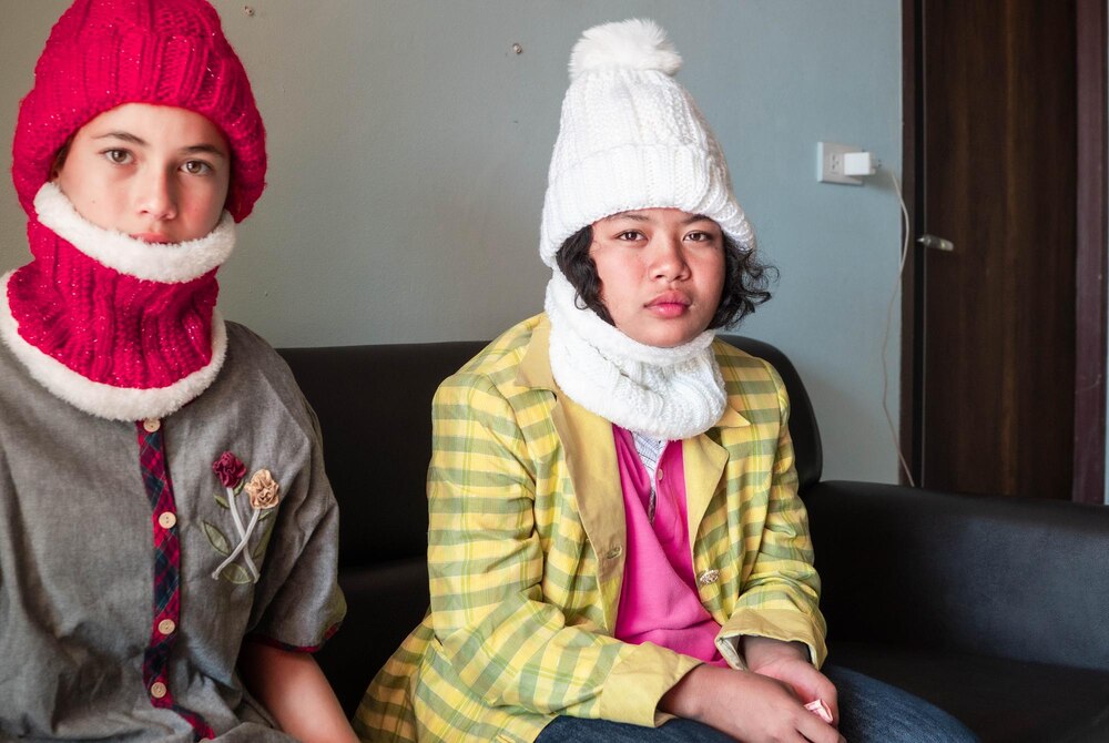 cute-womans-winter-fashion-knitted-hat-sitting-sofa-inside-house-two-people-red-white-hat_1048944-29216579.jpg