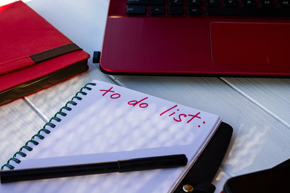 notebook-with-list-with-phone-red-diary-laptop-white-wooden-background_349071-1184.jpg